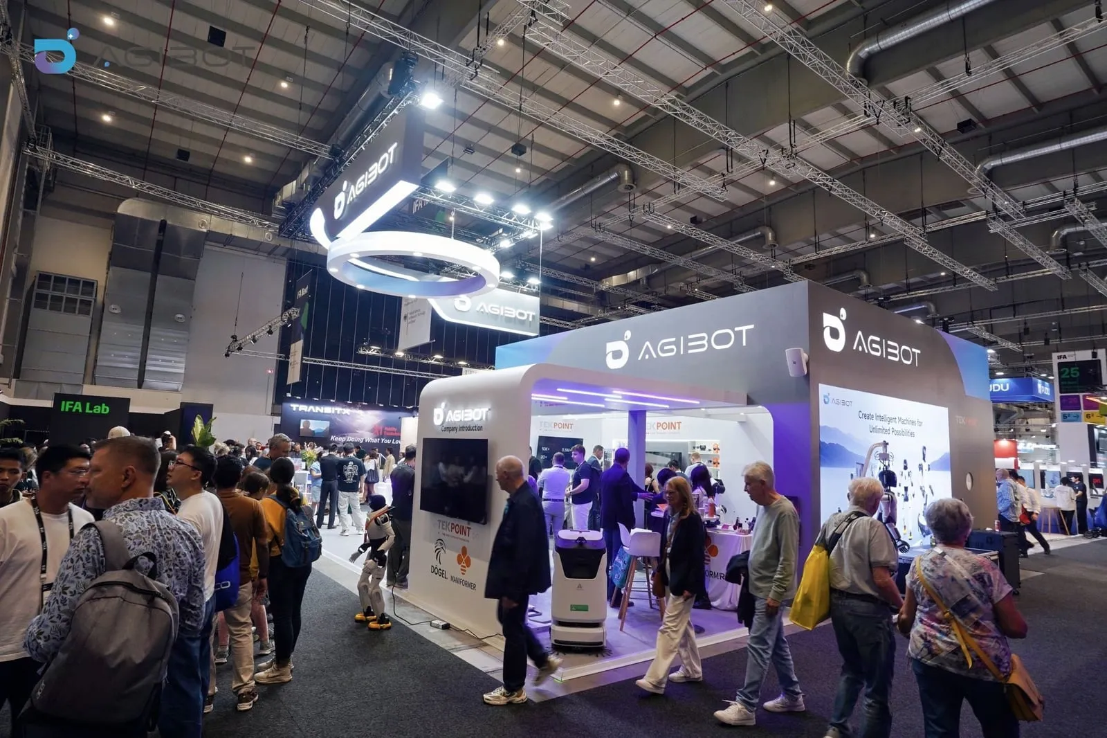 A wide view of the AGIBOT booth at IFA 2026 with visitors around the cleaning robots